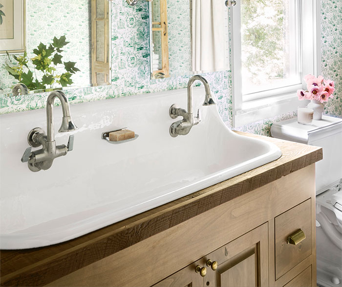 double bathroom sink in wooden cabinetry